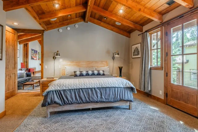 a bedroom with a bed lamp and a large window