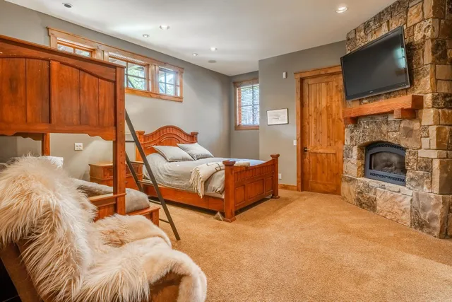 a spacious bedroom with a bed and a flat screen tv