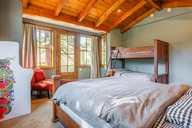 a bedroom with a bed and a window with couch