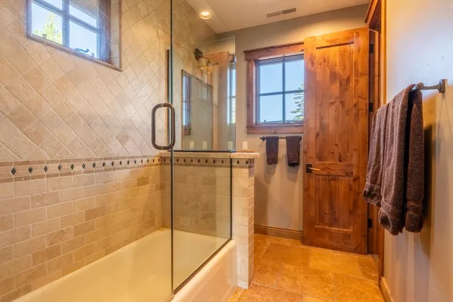 a bathroom with a shower and a sink