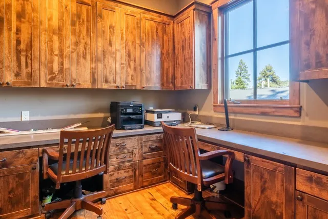 a kitchen with a chair a table and chairs in it