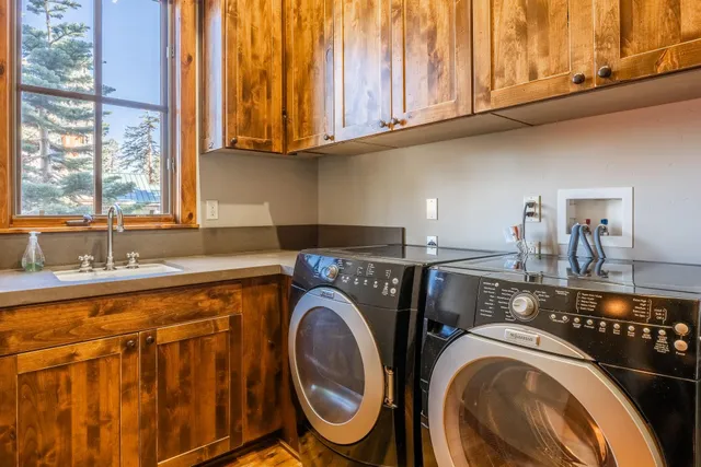 a kitchen with stainless steel appliances granite countertop a sink and a stove next to a window
