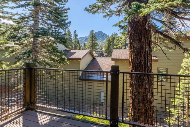 a view of balcony with floor to ceiling window and wooden fence