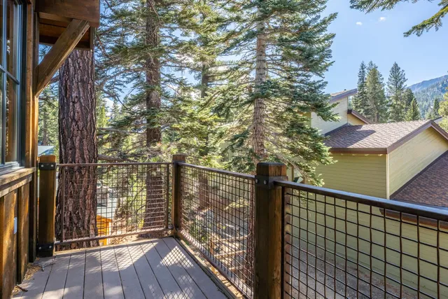a view of balcony with wooden floor and fence