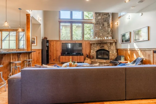 a living room with furniture a fireplace and a flat screen tv