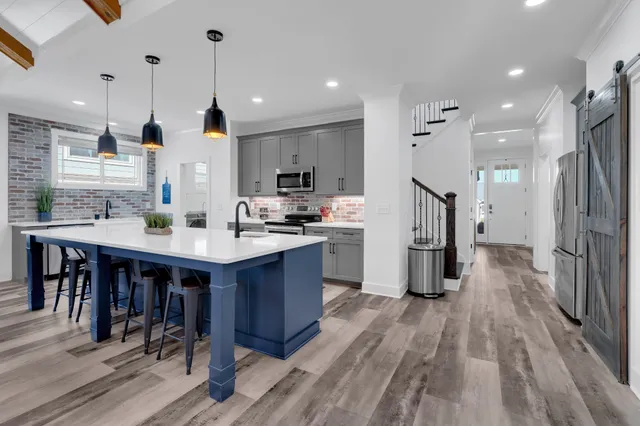 a kitchen with stainless steel appliances kitchen island a large island in the center