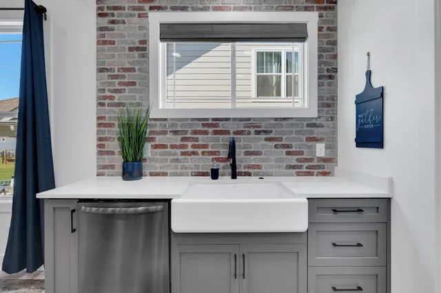 a utility room with cabinets washer and dryer
