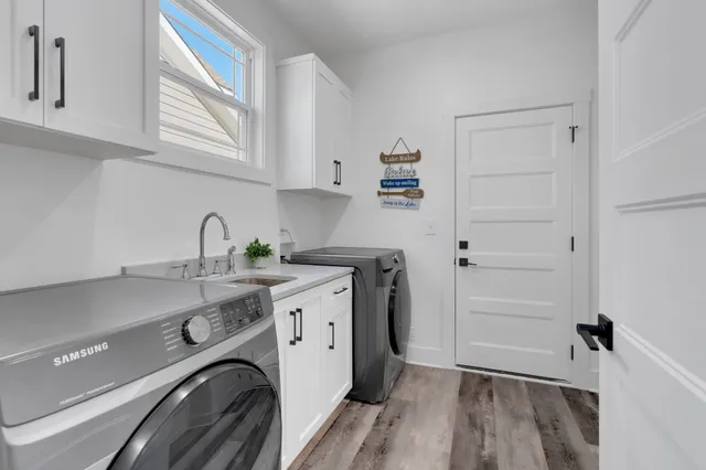a spacious bathroom with a double vanity sink a large mirror a bathtub and a window