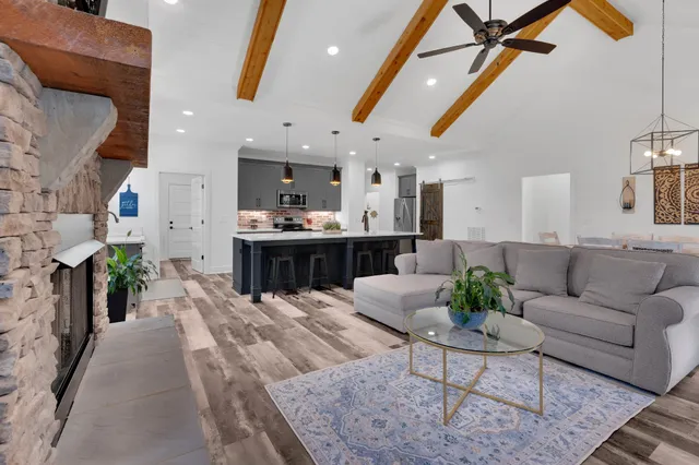 a kitchen with stainless steel appliances white cabinets granite counter tops and a stove