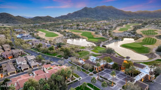 a view of a patio with a table and chairs under an umbrella
