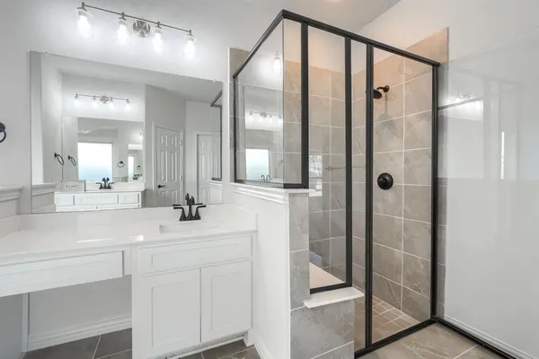 a bathroom with a double vanity sink mirror and shower