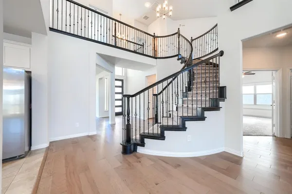 a view of entryway and hall with wooden floor