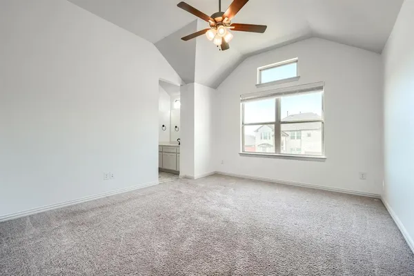 an empty room with a window and a ceiling fan