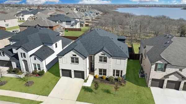 an aerial view of residential houses with outdoor space and parking