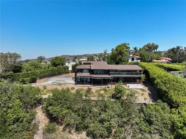 a backyard of a house with a yard and outdoor seating