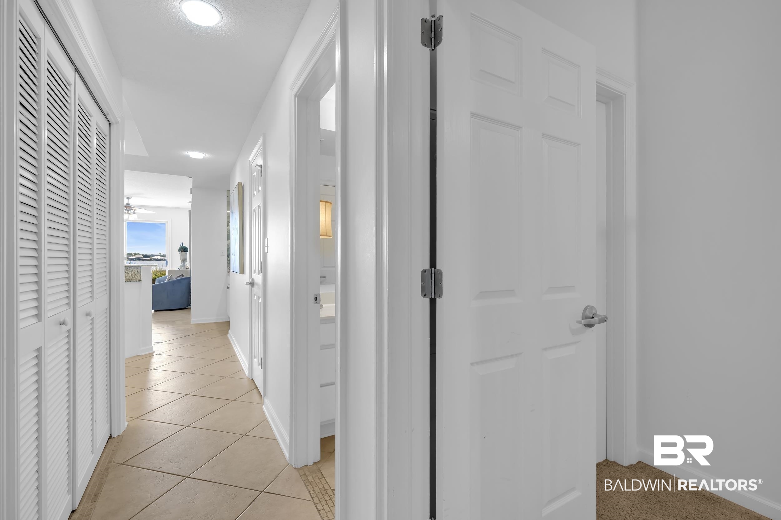 27282 Canal Road, Unit 104 Orange Beach, AL 36561 - Photo 46 of 79 Hall with light tile patterned floors and recessed lighting