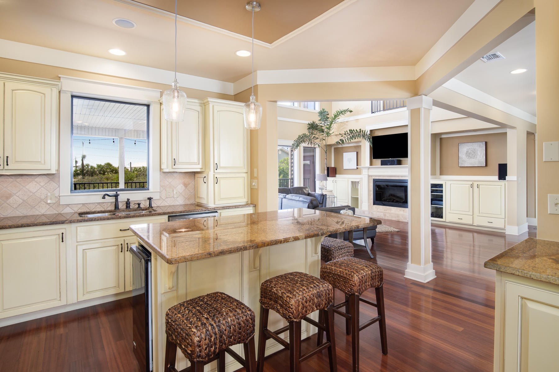 59 Baird Road Santa Rosa Beach, FL 32459 - Photo 22 of 24 a kitchen with a dining table chairs cabinets wooden floor and appliances