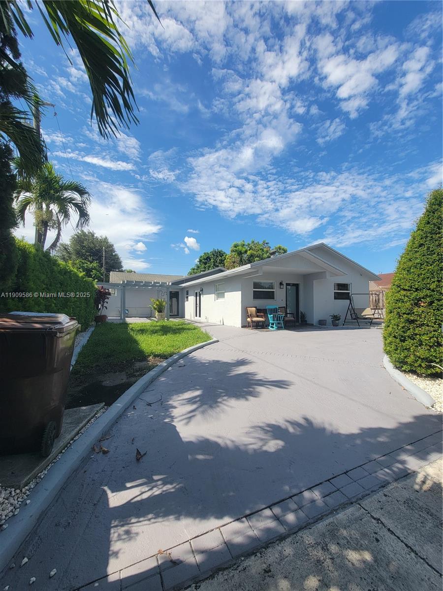 25 East 53rd Terrace Hialeah, FL 33013 - Photo 2 of 8 a front view of a house with a yard