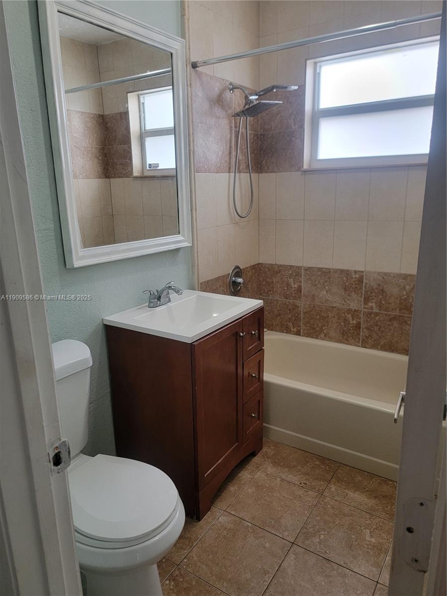 25 East 53rd Terrace Hialeah, FL 33013 - Photo 6 of 8 a bathroom with a sink a toilet and shower