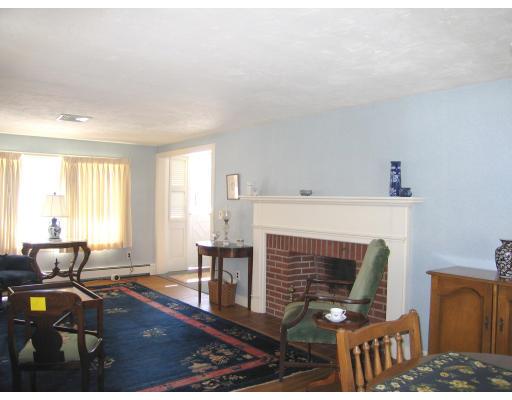 72 Gleason Road Reading, MA 01867 - Photo 2 of 9 a living room with furniture dining table and a fireplace