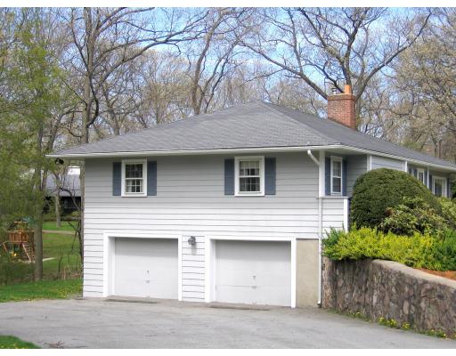 72 Gleason Road Reading, MA 01867 - Photo 9 of 9 a front view of a house with a garden and trees