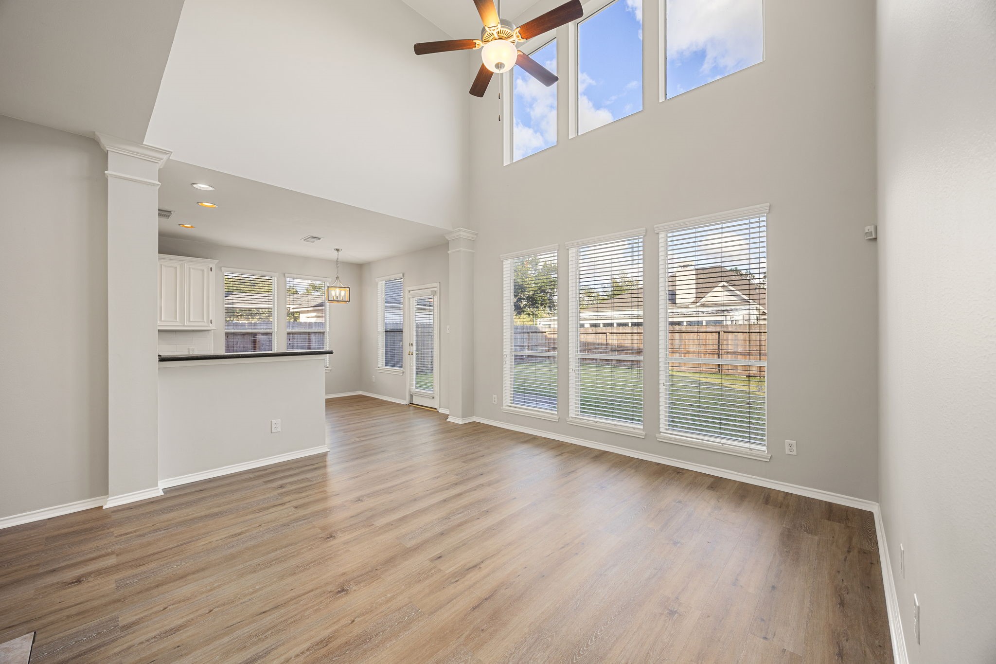 3707 Pecan Court Manvel, TX 77578 - Photo 4 of 35 a view of an empty room with wooden floor and a kitchen