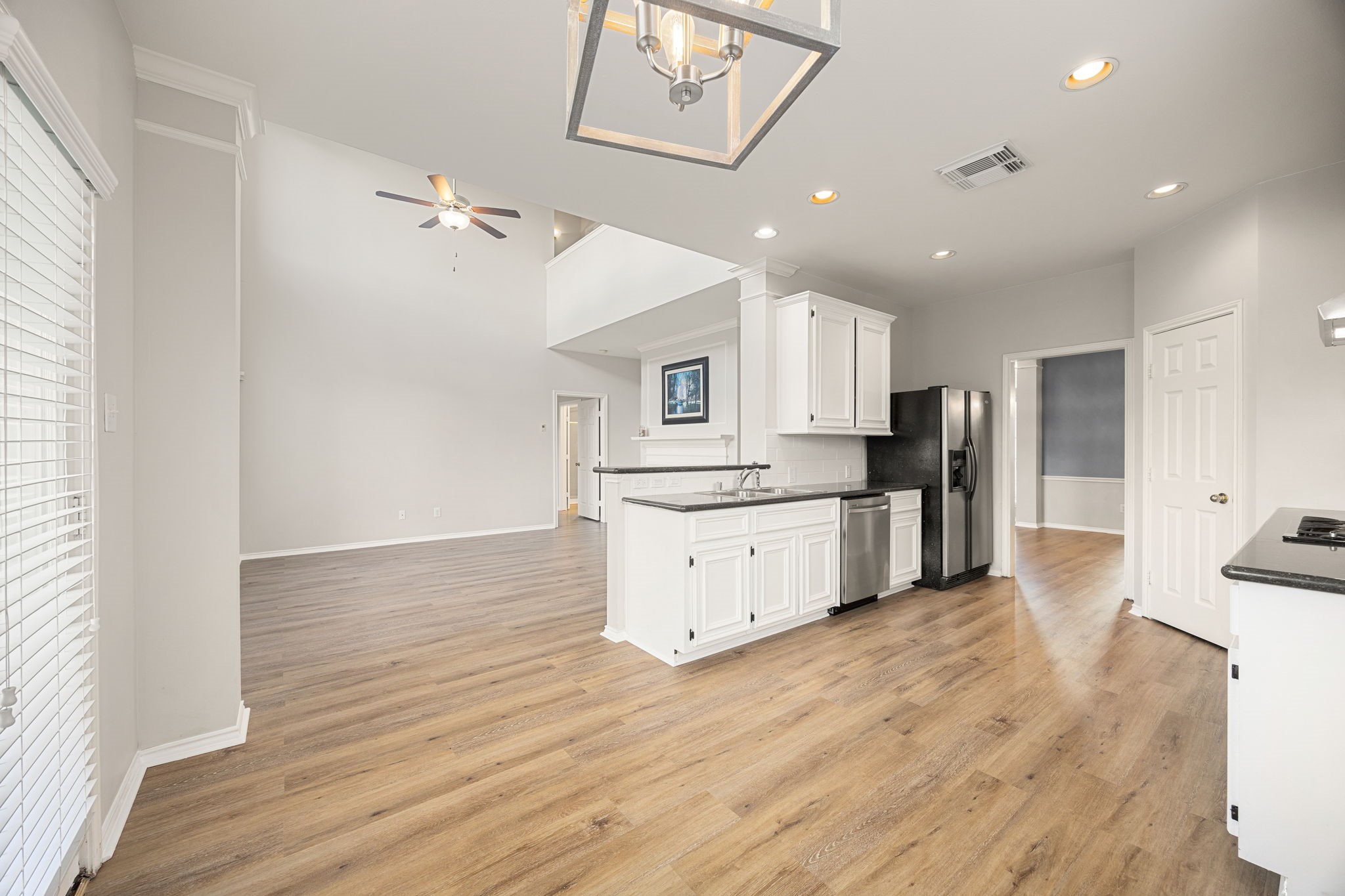 3707 Pecan Court Manvel, TX 77578 - Photo 6 of 35 a large kitchen with a center island wooden floor stainless steel appliances and cabinets