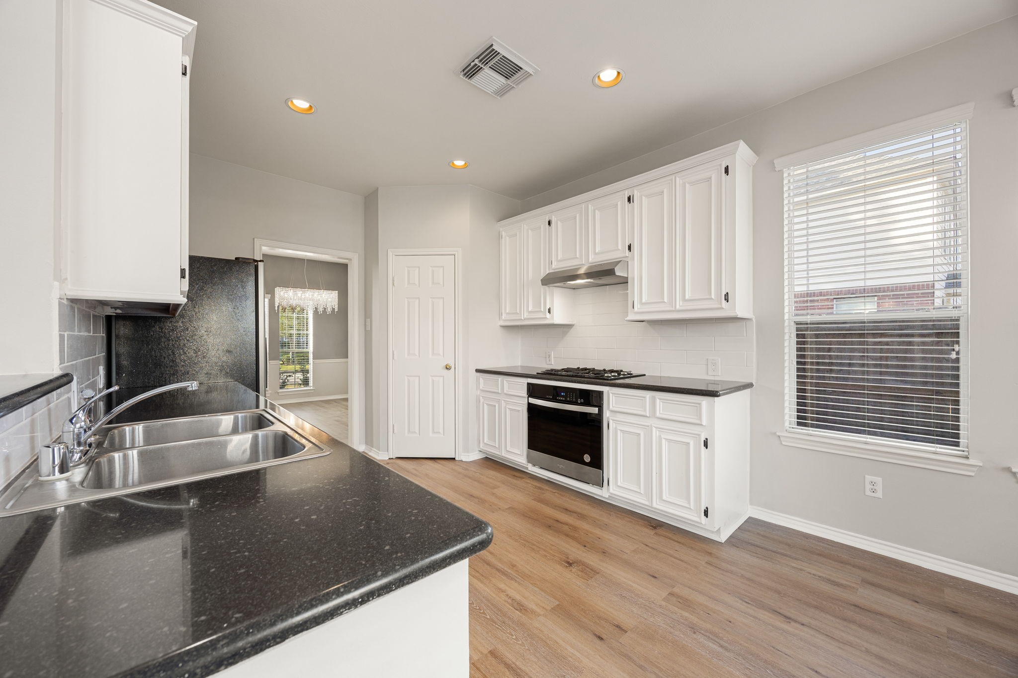 3707 Pecan Court Manvel, TX 77578 - Photo 7 of 35 a kitchen with granite countertop a sink stainless steel appliances and cabinets