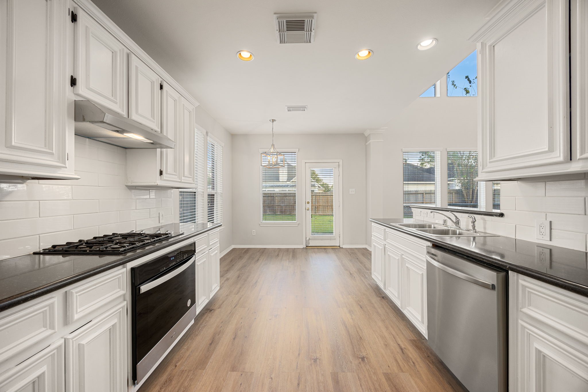 3707 Pecan Court Manvel, TX 77578 - Photo 8 of 35 a kitchen with stainless steel appliances granite countertop a stove a sink and a refrigerator