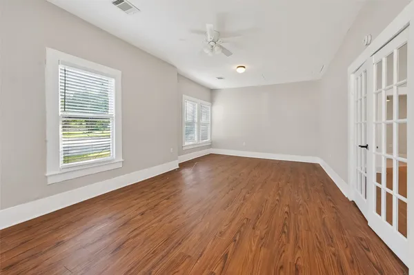 wooden floor in an empty room with a window