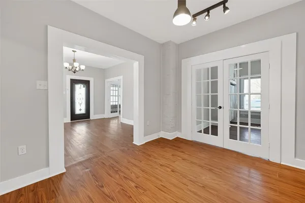 a view of a livingroom with wooden floor and a window