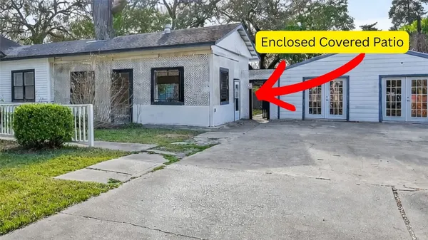 a sign board with a road and front door