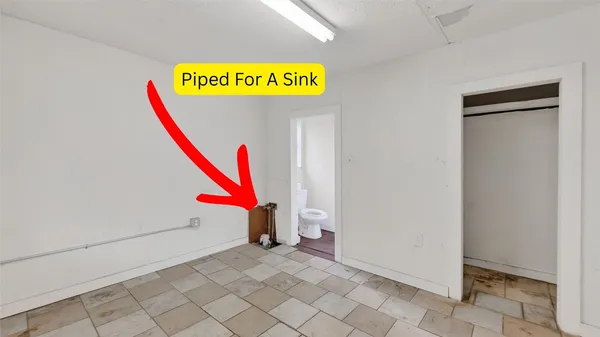 a room with a bench and a wooden floor