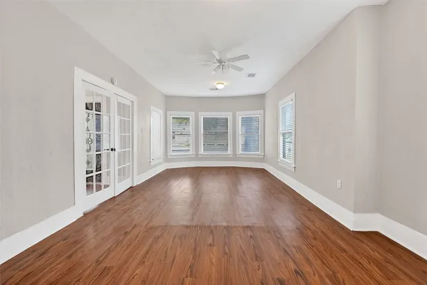 wooden floor in an empty room with a window