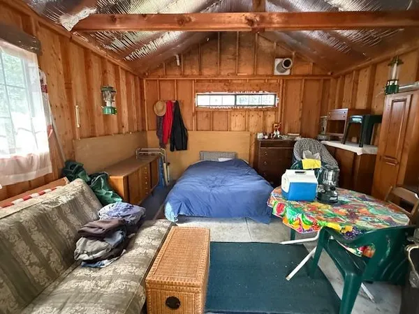 a bedroom with furniture and a window