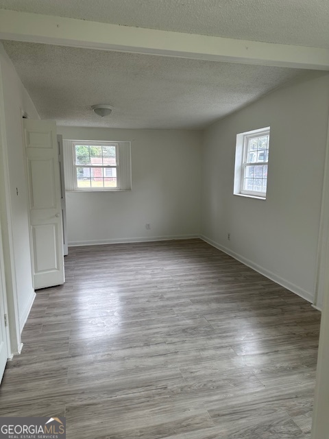 527 Carteret Road Brunswick, GA 31525 - Photo 12 of 23 an empty room with wooden floor and windows