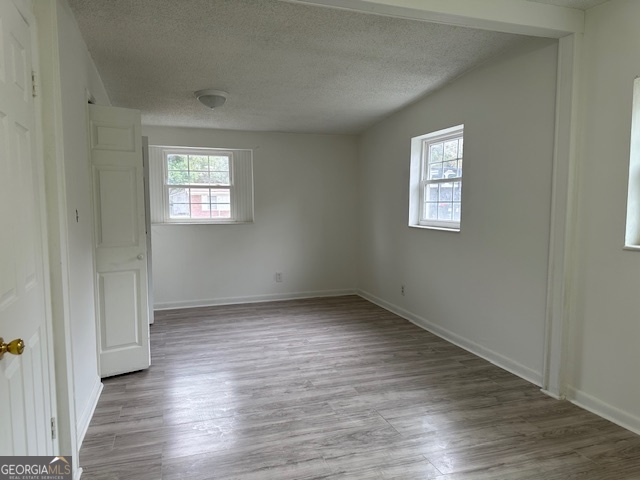 527 Carteret Road Brunswick, GA 31525 - Photo 15 of 23 an empty room with wooden floor and windows