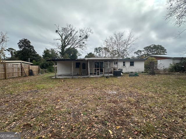 527 Carteret Road Brunswick, GA 31525 - Photo 21 of 23 a front view of a house with a garden and trees