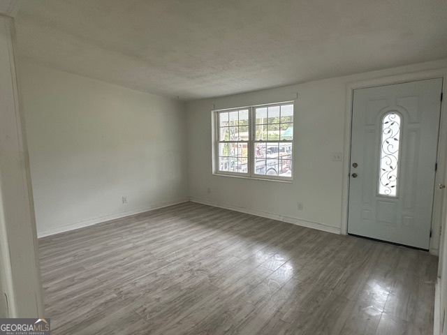527 Carteret Road Brunswick, GA 31525 - Photo 3 of 23 an empty room with wooden floor and windows