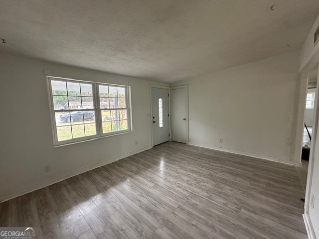 527 Carteret Road Brunswick, GA 31525 - Photo 4 of 23 an empty room with wooden floor and windows