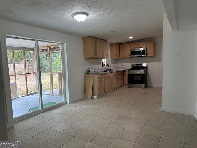 527 Carteret Road Brunswick, GA 31525 - Photo 6 of 23 a kitchen with stainless steel appliances granite countertop a stove top oven a sink a dining table and chairs