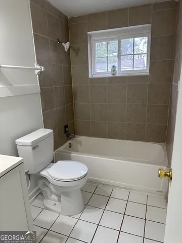a bathroom with a toilet a sink and bathtub