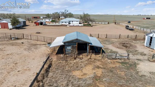 a view of a house with wooden fence