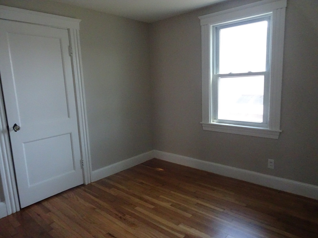 26 Hobson Street Methuen, MA 01844 - Photo 17 of 26 an empty room with wooden floor and windows