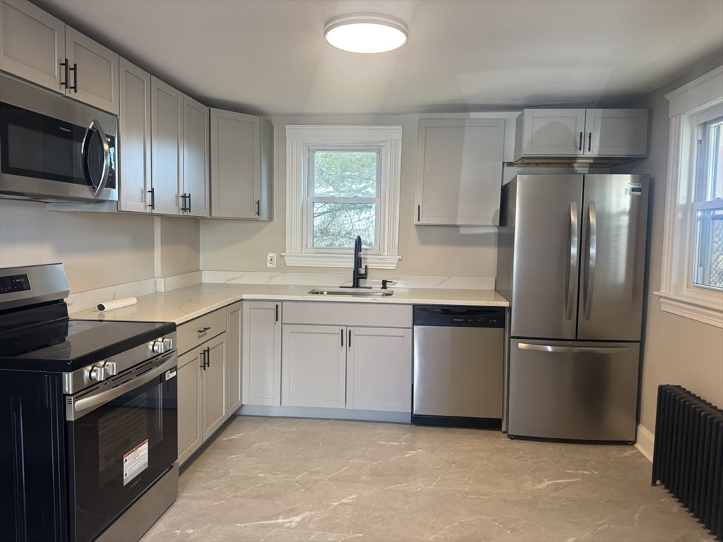 26 Hobson Street Methuen, MA 01844 - Photo 4 of 26 a kitchen with a refrigerator stove and microwave
