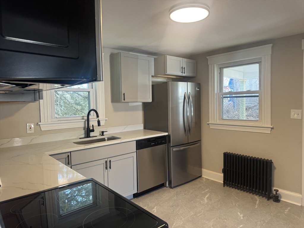 26 Hobson Street Methuen, MA 01844 - Photo 5 of 26 a kitchen with stainless steel appliances granite countertop a refrigerator a sink and a stove
