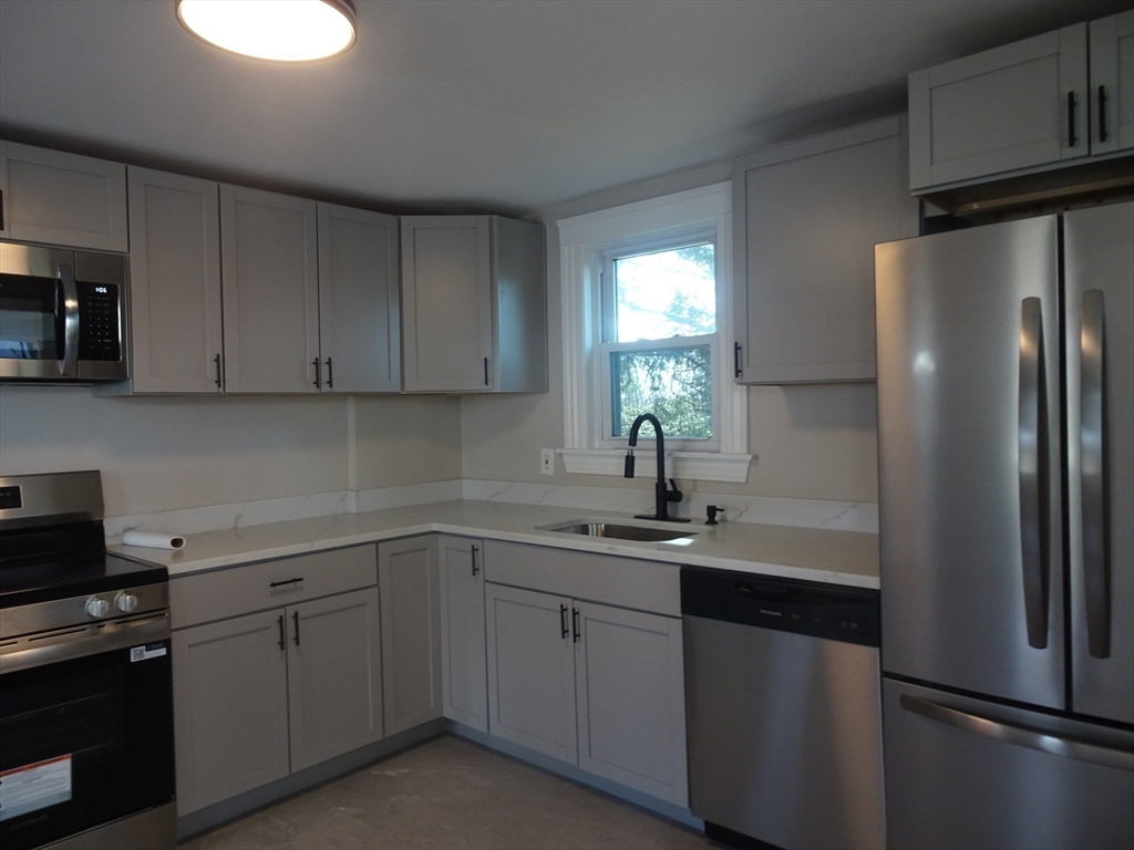 26 Hobson Street Methuen, MA 01844 - Photo 6 of 26 a kitchen with a refrigerator sink and cabinets