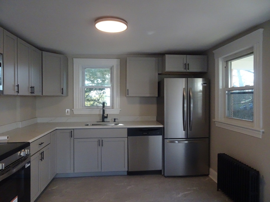 26 Hobson Street Methuen, MA 01844 - Photo 7 of 26 a kitchen with a refrigerator sink and cabinets