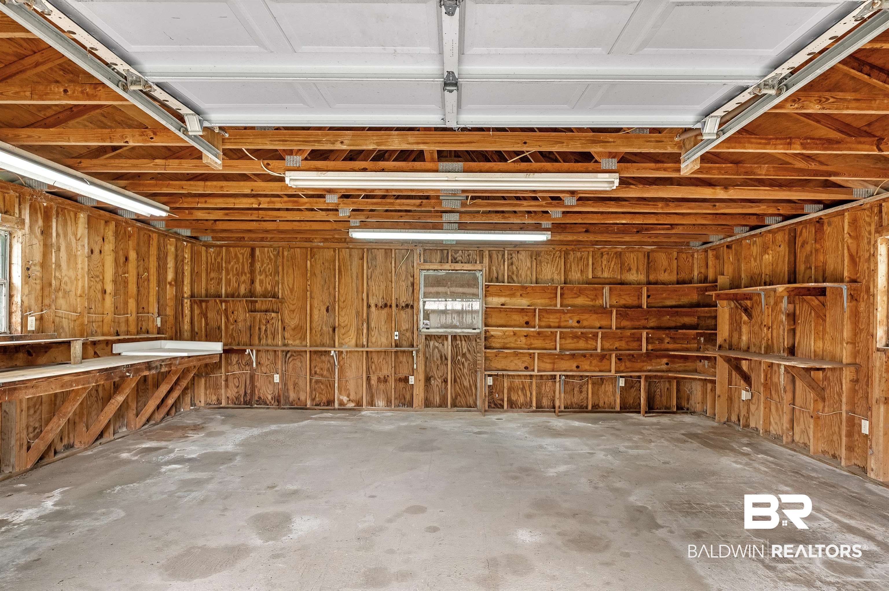 22810 Ard Road Robertsdale, AL 36567 - Photo 60 of 65 Garage featuring wooden walls