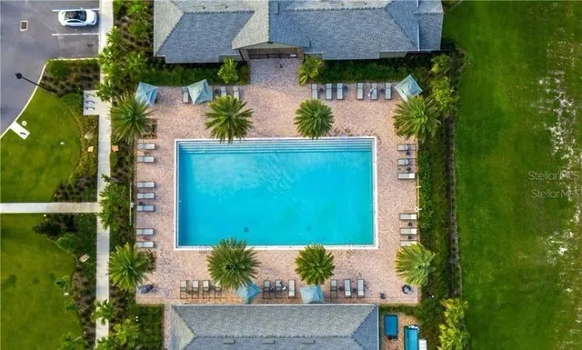 a living room with furniture a flat screen tv and a large window